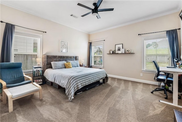 bedroom featuring ceiling fan, carpet, baseboards, visible vents, and ornamental molding