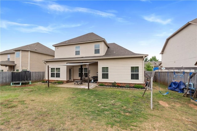 back of property featuring a fenced backyard, a trampoline, a lawn, and a patio