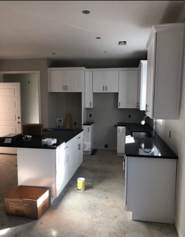 kitchen featuring sink and white cabinets