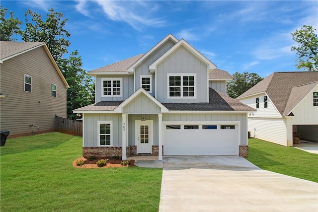 363 Lightness Dr, Auburn, AL 36832 - view of front of house featuring a front lawn, roof with shingles, brick siding, board and batten siding, and concrete driveway