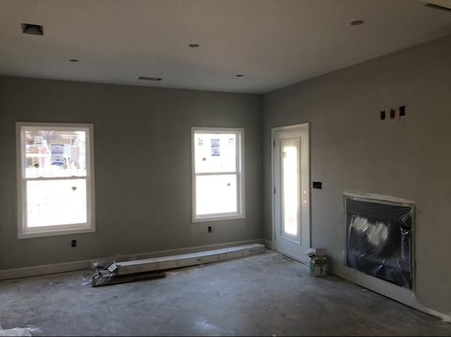 unfurnished living room featuring a wealth of natural light