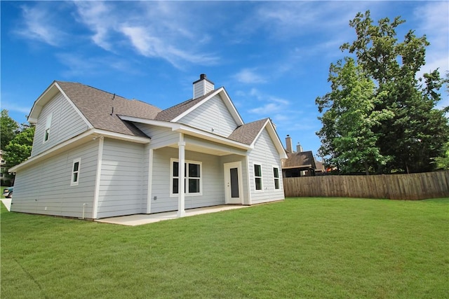 363 Lightness Dr, Auburn, AL 36832 - back of house with a lawn, fence, a chimney, and a patio area