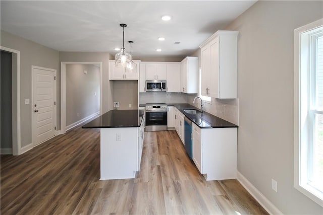 363 Lightness Dr, Auburn, AL 36832 - kitchen featuring a sink, appliances with stainless steel finishes, backsplash, and dark countertops