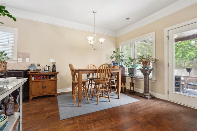 1107 Hampstead Ln, Opelika, AL 36801 - dining room with healthy amount of natural light, wood finished floors, ornamental molding, a chandelier, and baseboards