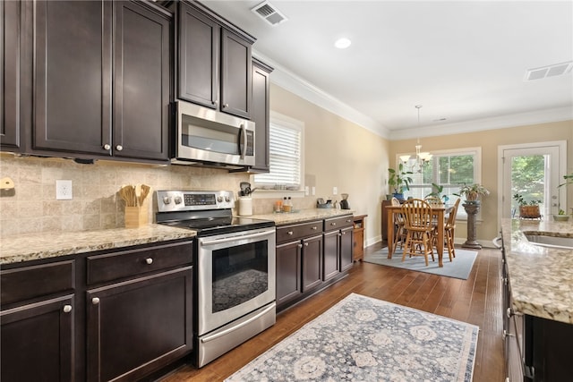 1107 Hampstead Ln, Opelika, AL 36801 - kitchen featuring stainless steel appliances, a sink, plenty of natural light, ornamental molding, and decorative backsplash