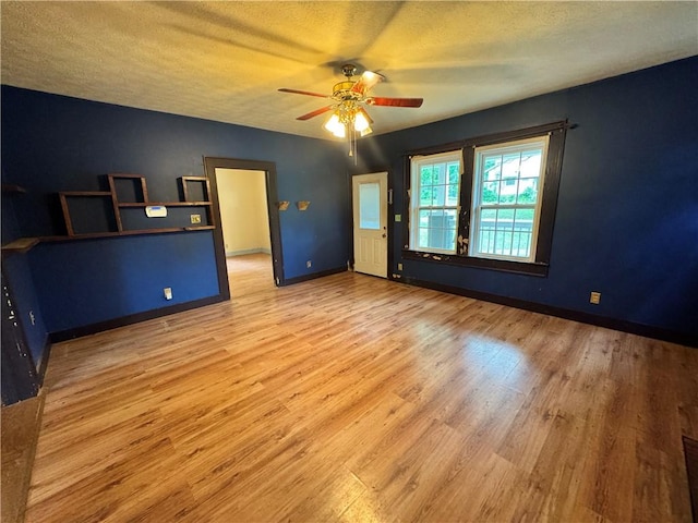202 E Railroad St, Valley, AL 36854 - unfurnished bedroom with wood finished floors, a textured ceiling, baseboards, and ceiling fan