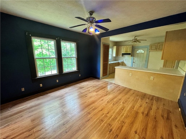 202 E Railroad St, Valley, AL 36854 - unfurnished living room featuring ceiling fan, light wood finished floors, a textured ceiling, and baseboards