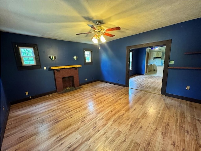 202 E Railroad St, Valley, AL 36854 - unfurnished living room with a ceiling fan, plenty of natural light, wood finished floors, and a textured ceiling