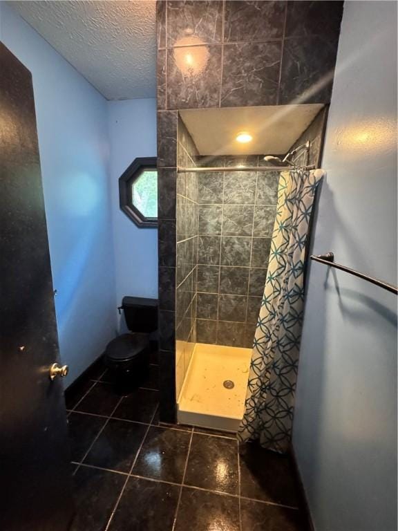 202 E Railroad St, Valley, AL 36854 - full bath with a shower stall, toilet, tile patterned floors, and a textured ceiling