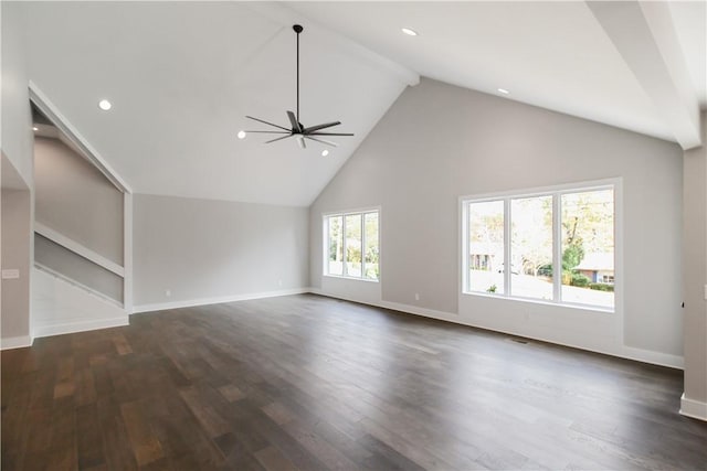 unfurnished living room with beam ceiling, ceiling fan, and dark hardwood / wood-style floors