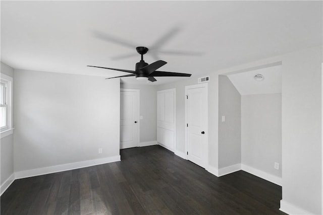 unfurnished room featuring ceiling fan and dark wood-type flooring