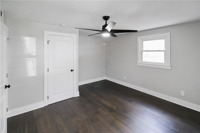 unfurnished bedroom featuring ceiling fan and dark hardwood / wood-style floors