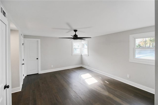 spare room featuring ceiling fan and dark hardwood / wood-style floors