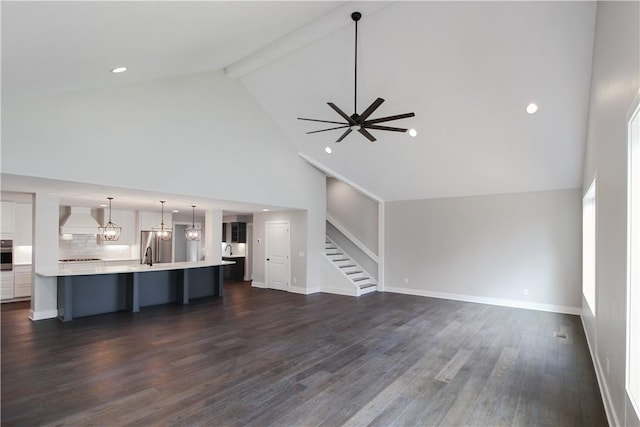 unfurnished living room featuring ceiling fan, beamed ceiling, dark hardwood / wood-style floors, and high vaulted ceiling