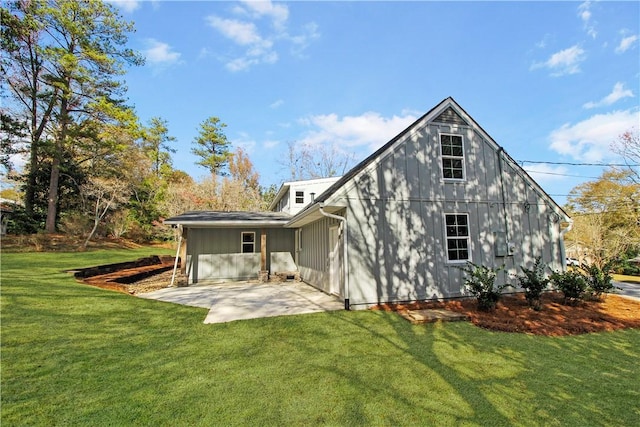 rear view of house with a lawn and a patio area