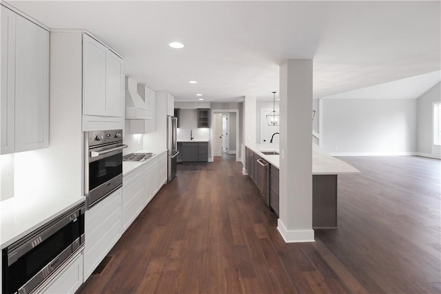 kitchen featuring white cabinets, decorative light fixtures, sink, and stainless steel appliances