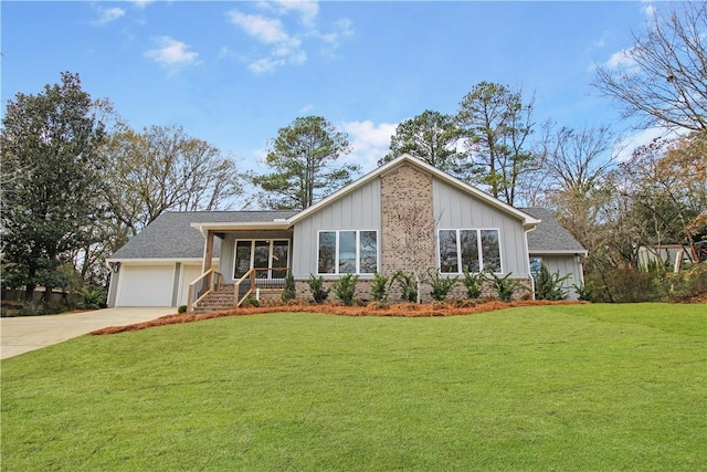 view of front of home with a garage and a front lawn