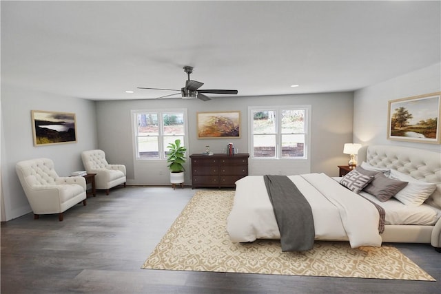 bedroom with hardwood / wood-style floors, ceiling fan, and multiple windows