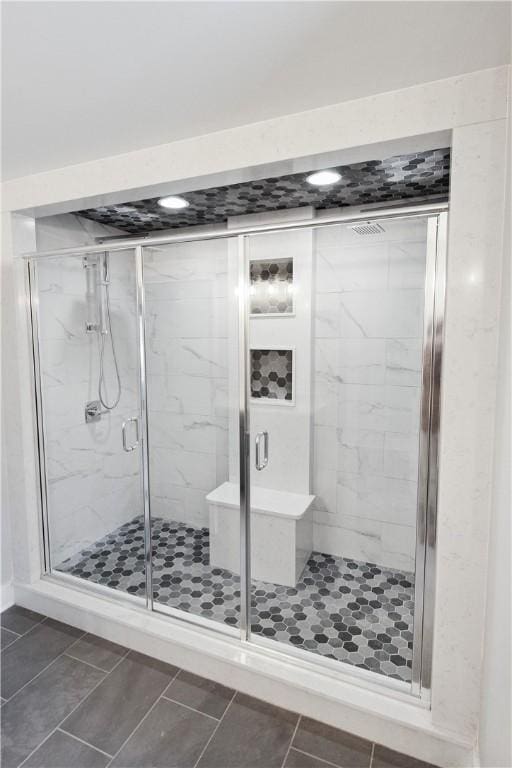 bathroom featuring tile patterned floors and a shower with shower door