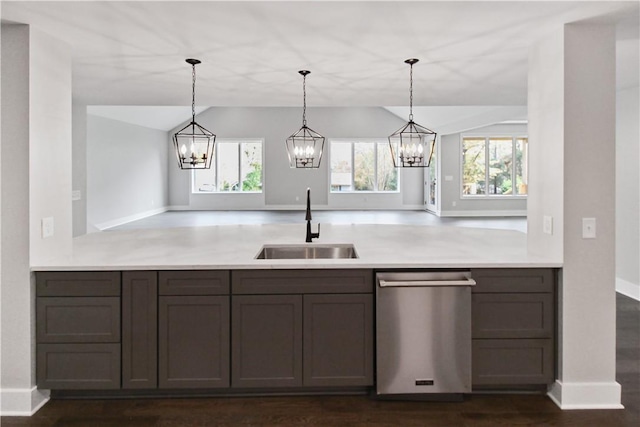 kitchen featuring dishwasher, decorative light fixtures, plenty of natural light, and sink