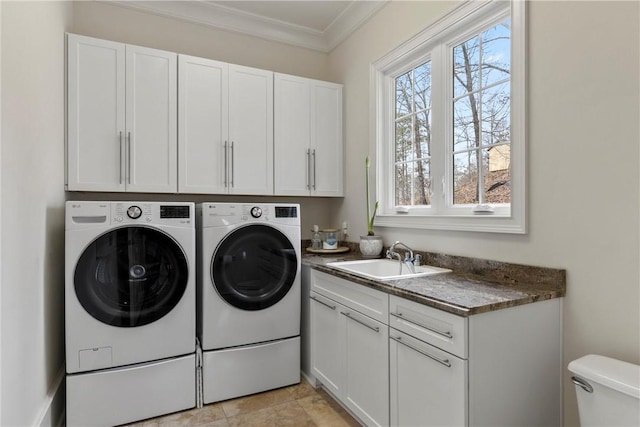 laundry area with washer and dryer, crown molding, sink, and cabinets