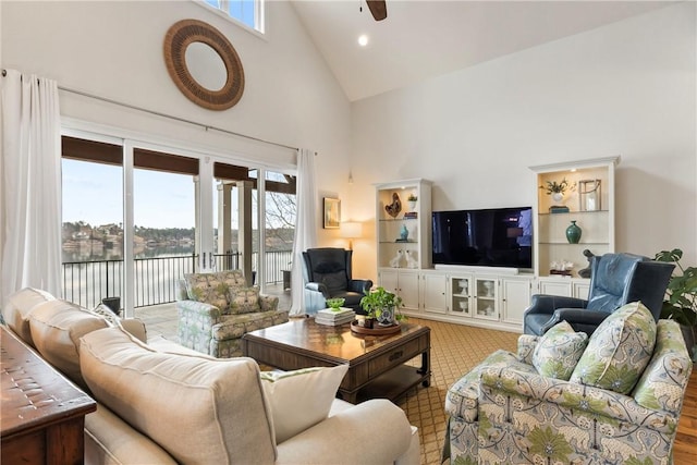 living room with ceiling fan and high vaulted ceiling