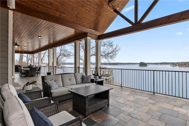 view of patio / terrace with a water view and outdoor lounge area