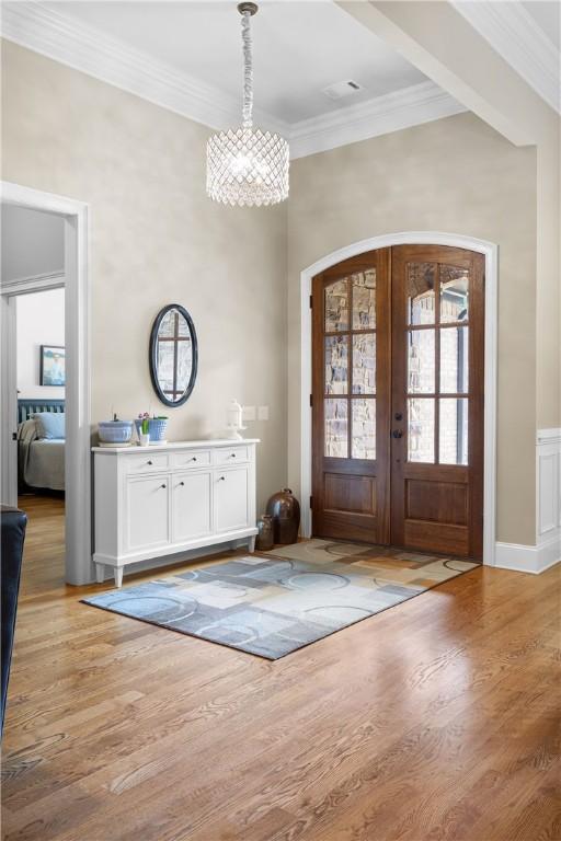 1579 Alex Ave, Auburn, AL 36830 - foyer entrance featuring ornamental molding, a chandelier, light wood finished floors, and french doors