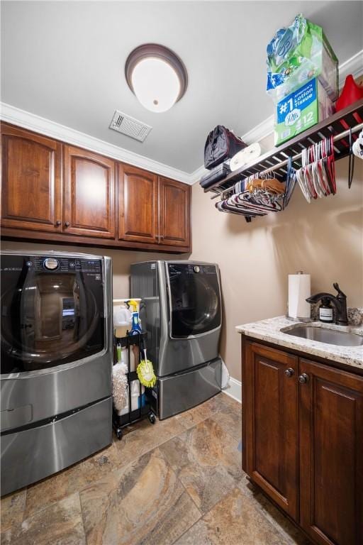 1579 Alex Ave, Auburn, AL 36830 - washroom featuring independent washer and dryer, cabinet space, stone finish floors, baseboards, and crown molding