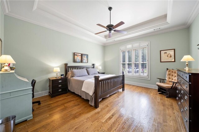 1579 Alex Ave, Auburn, AL 36830 - bedroom with a tray ceiling, wood finished floors, ornamental molding, baseboards, and a ceiling fan
