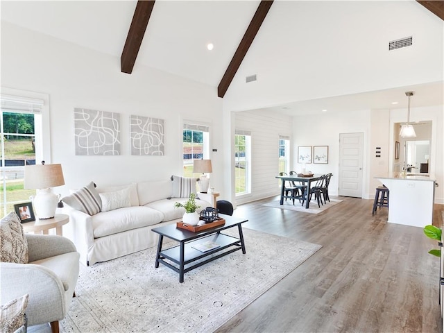 0104 Bradley Ln, Auburn, AL 36830 - living area featuring beamed ceiling, healthy amount of natural light, high vaulted ceiling, wood finished floors, and recessed lighting