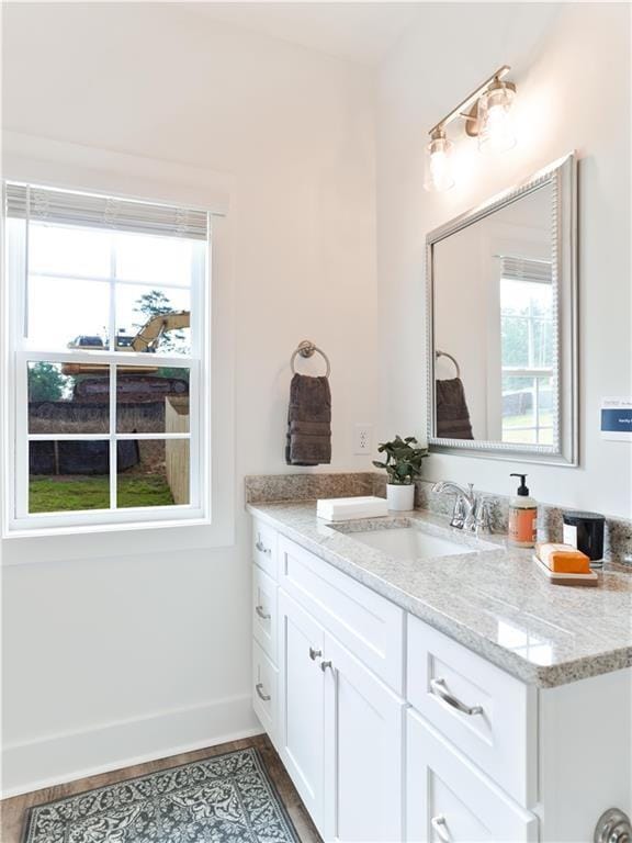 0104 Bradley Ln, Auburn, AL 36830 - bathroom featuring vanity, plenty of natural light, baseboards, and wood finished floors