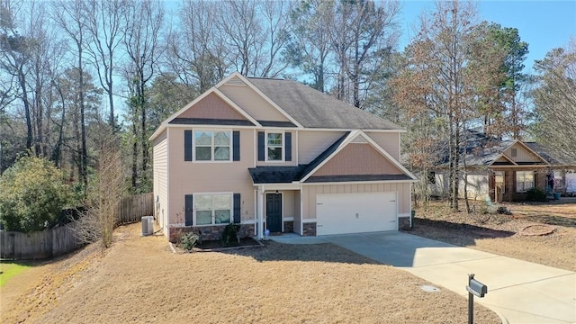 craftsman-style house with a garage, central AC unit, concrete driveway, stone siding, and fence