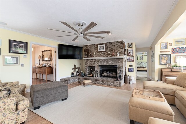 2500 Ridge Rd, Opelika, AL 36801 - living area with crown molding, wood finished floors, ceiling fan, and a brick fireplace