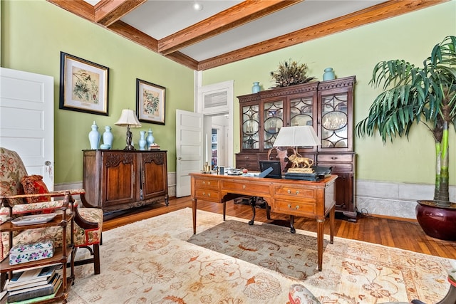 office area with beam ceiling, coffered ceiling, and hardwood / wood-style flooring