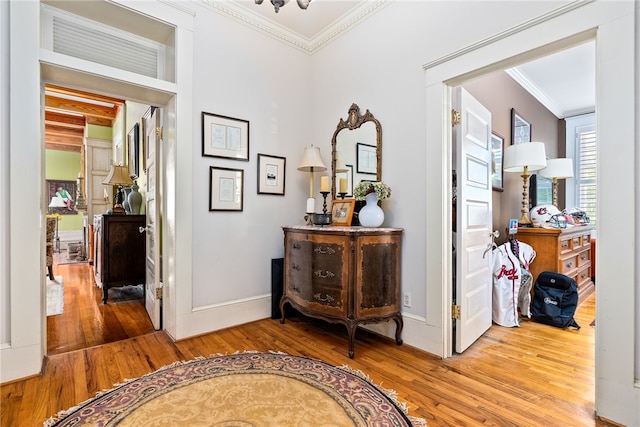 hallway with hardwood / wood-style floors and crown molding