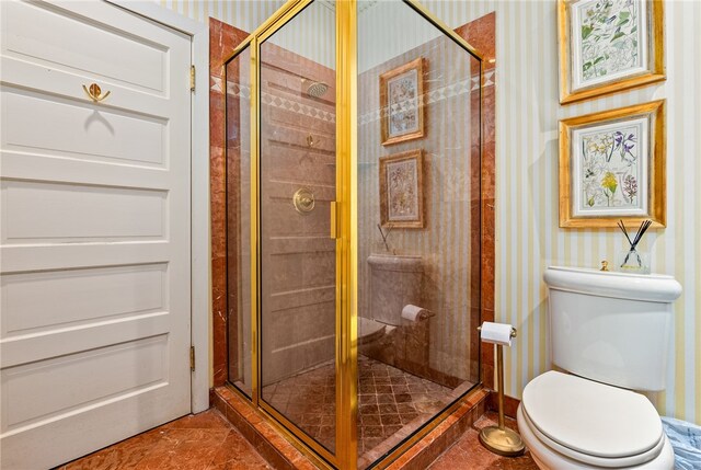 bathroom featuring tile patterned floors, toilet, and an enclosed shower