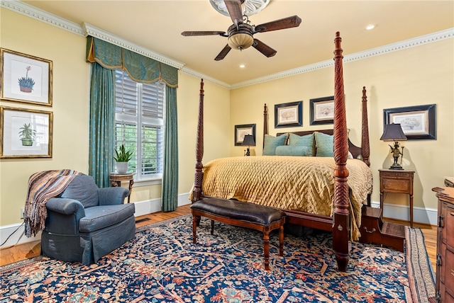 bedroom featuring wood-type flooring, ceiling fan, and crown molding