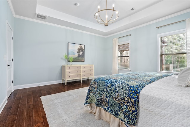 bedroom featuring a tray ceiling, multiple windows, wood-type flooring, and baseboards