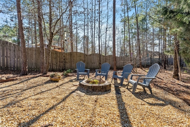 view of yard with a fire pit and fence