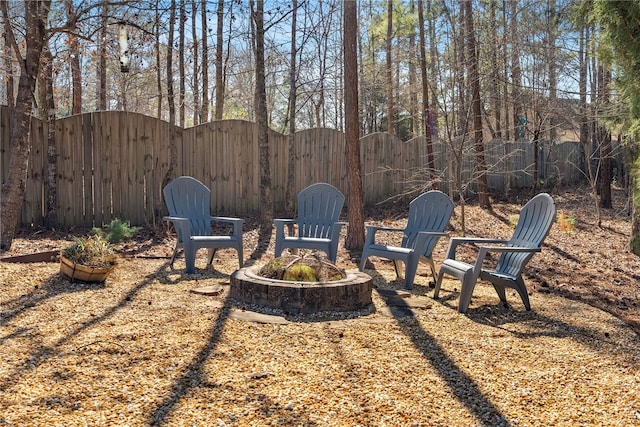 view of yard with a fire pit, a gate, and fence