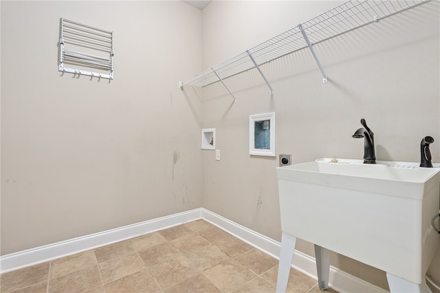 clothes washing area featuring laundry area, washer hookup, a sink, baseboards, and electric dryer hookup