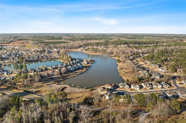 birds eye view of property featuring a water view and a view of trees