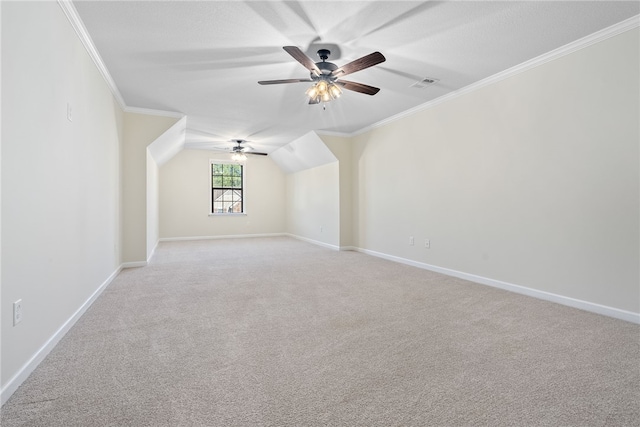 additional living space featuring light carpet, baseboards, visible vents, a ceiling fan, and vaulted ceiling