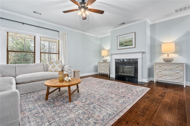 living area with visible vents and ornamental molding