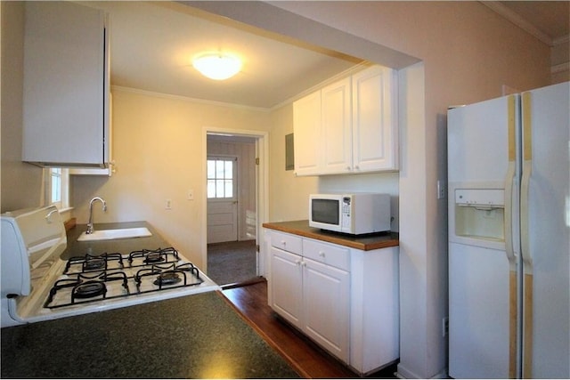 kitchen featuring white cabinetry, sink, dark hardwood / wood-style flooring, crown molding, and white appliances