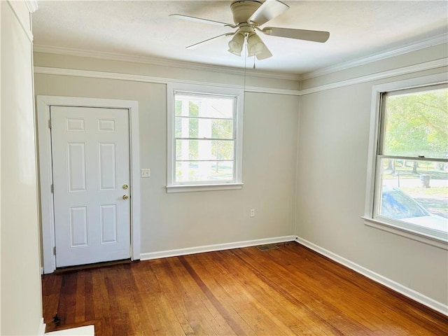 entrance foyer with hardwood / wood-style flooring, ornamental molding, and ceiling fan