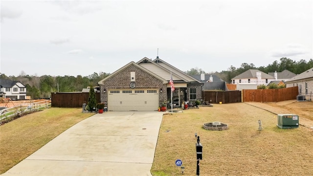 view of front of property with a garage, a front yard, central air condition unit, and an outdoor fire pit