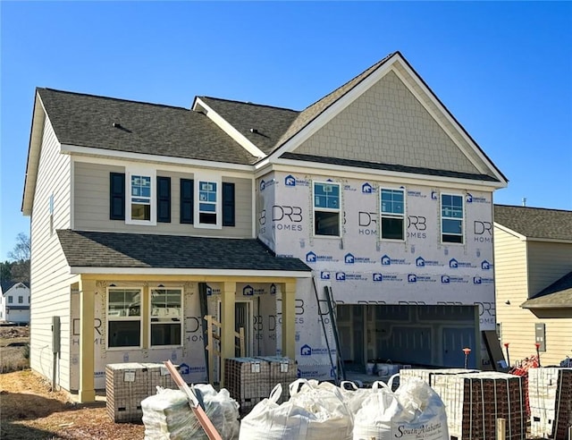 view of front of property with a porch and a garage