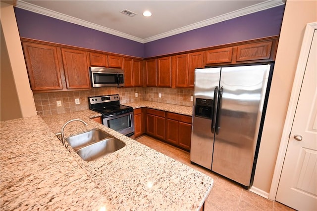 kitchen with sink, backsplash, stainless steel appliances, light stone counters, and kitchen peninsula